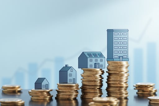 Stacks of coins growing and illustrations of real estate growing on top of them