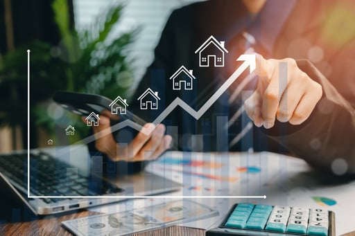 Real estate investment portfolio growing concept. Broker using laptop and calculator